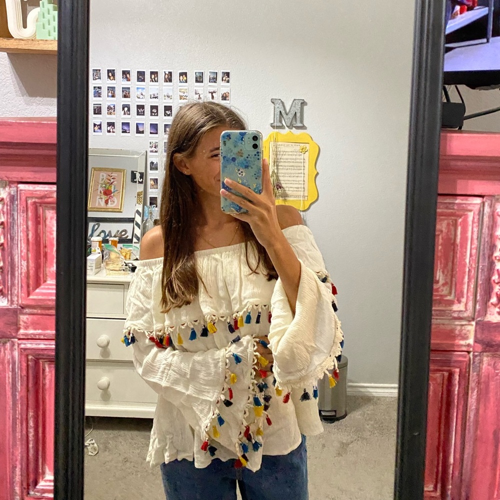 White Top with colorful fringe lining the ends